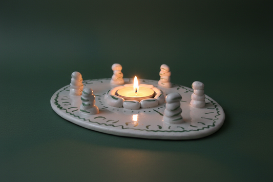 Green handmade ceramic tealight holder displayed as a candle centerpiece
