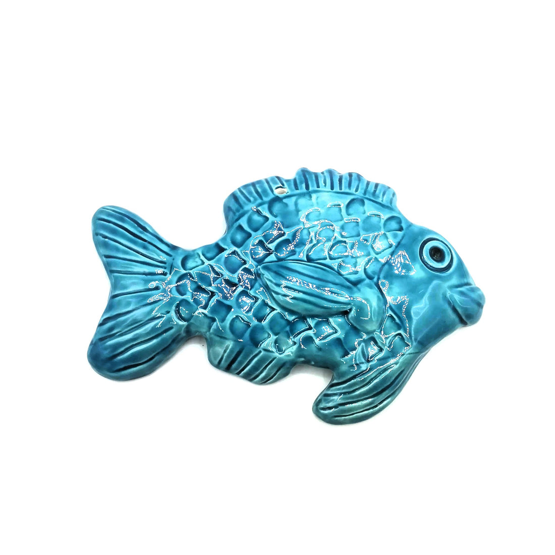 A blue ceramic fish on a white background