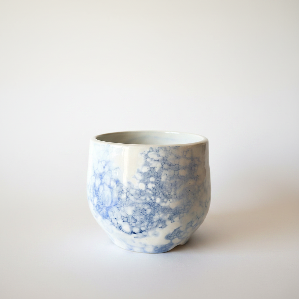 Ceramic cup with blue pattern on a white background