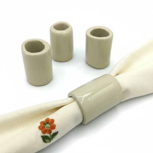 Set of four handmade beige stoneware napkin rings