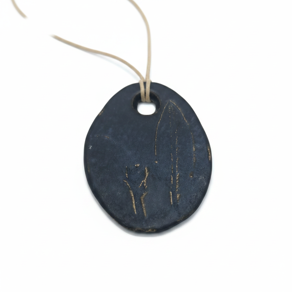 Large sage ceramic leaf pendant on a white background