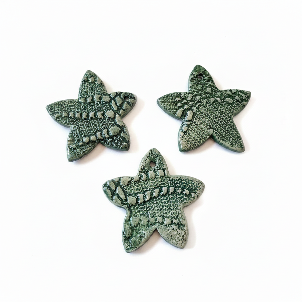 Set of three green handmade ceramic star ornaments