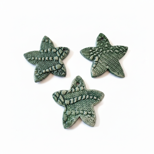 Set of three green handmade ceramic star ornaments