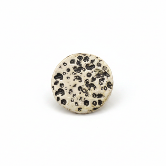 Handmade beige ceramic moon brooch with textured full-moon design