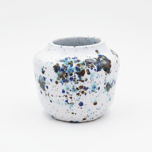Handmade speckled ceramic bud vase on white background